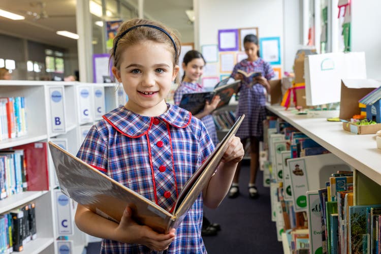 A student reading a picture book in Normanhurst Public School library.