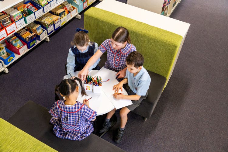 A group of Normmanhurst Public School students studying in the school library.